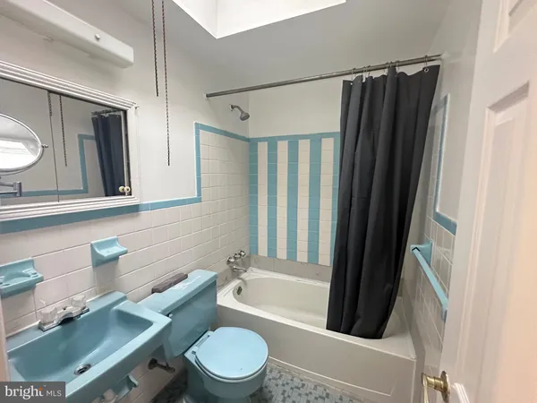 a bathroom with a toilet a sink and bathtub