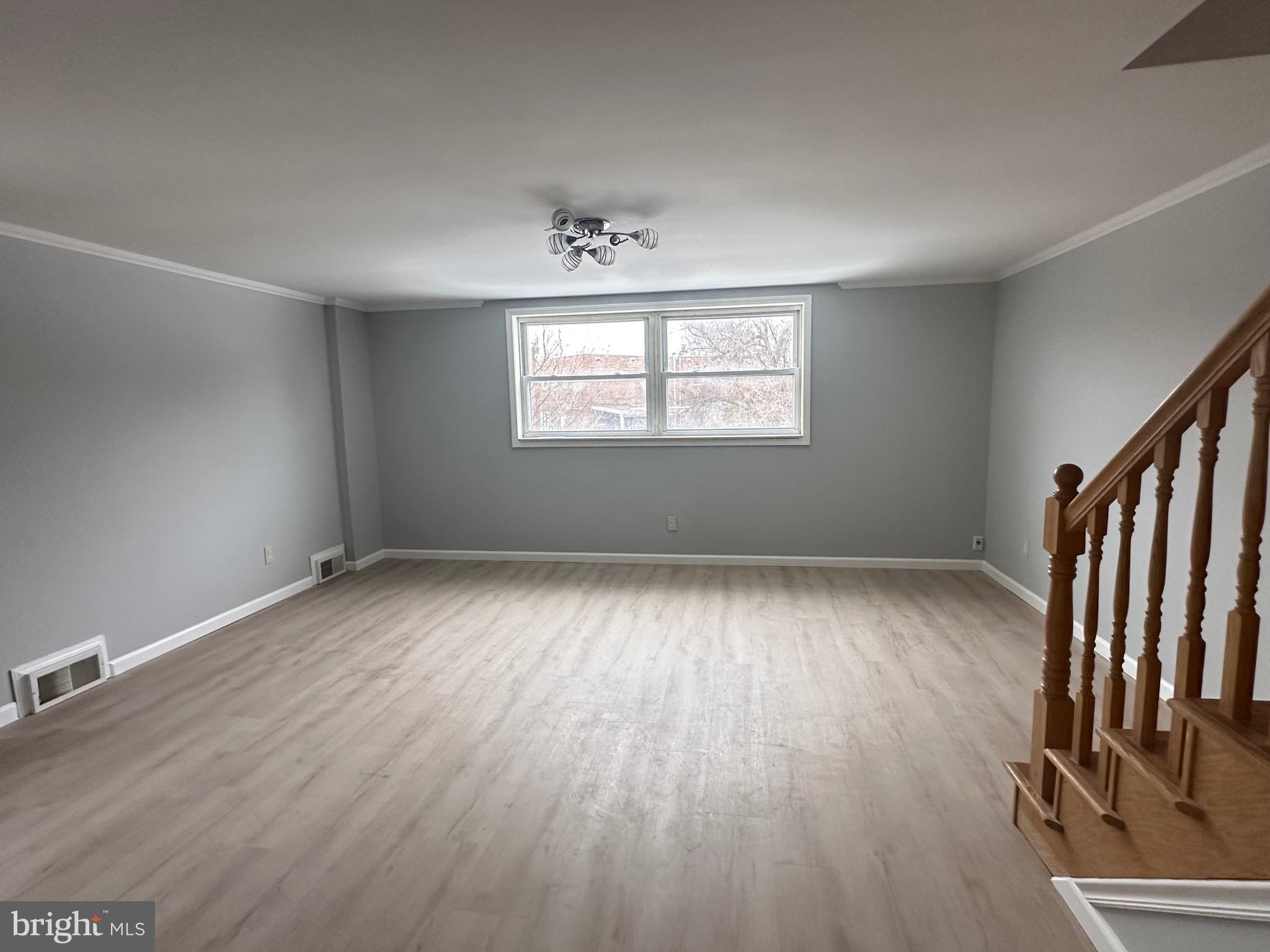 346 Ridgeway Place Philadelphia, PA 19116 - Photo 2 of 19 an empty room with wooden floor and windows