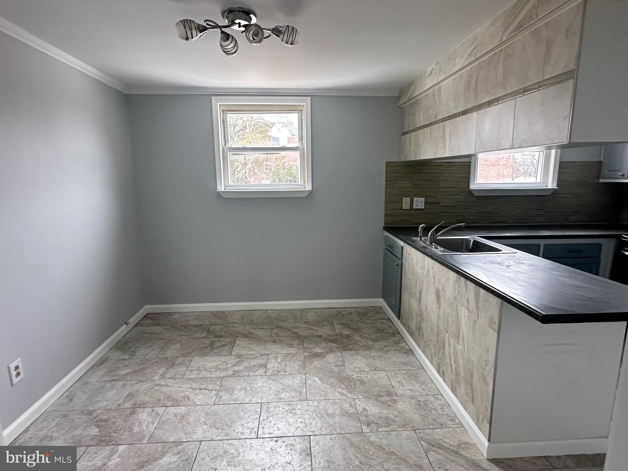 346 Ridgeway Place Philadelphia, PA 19116 - Photo 7 of 19 a kitchen with a sink a counter top space and a window