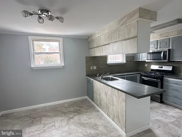 a kitchen with a stove and a microwave