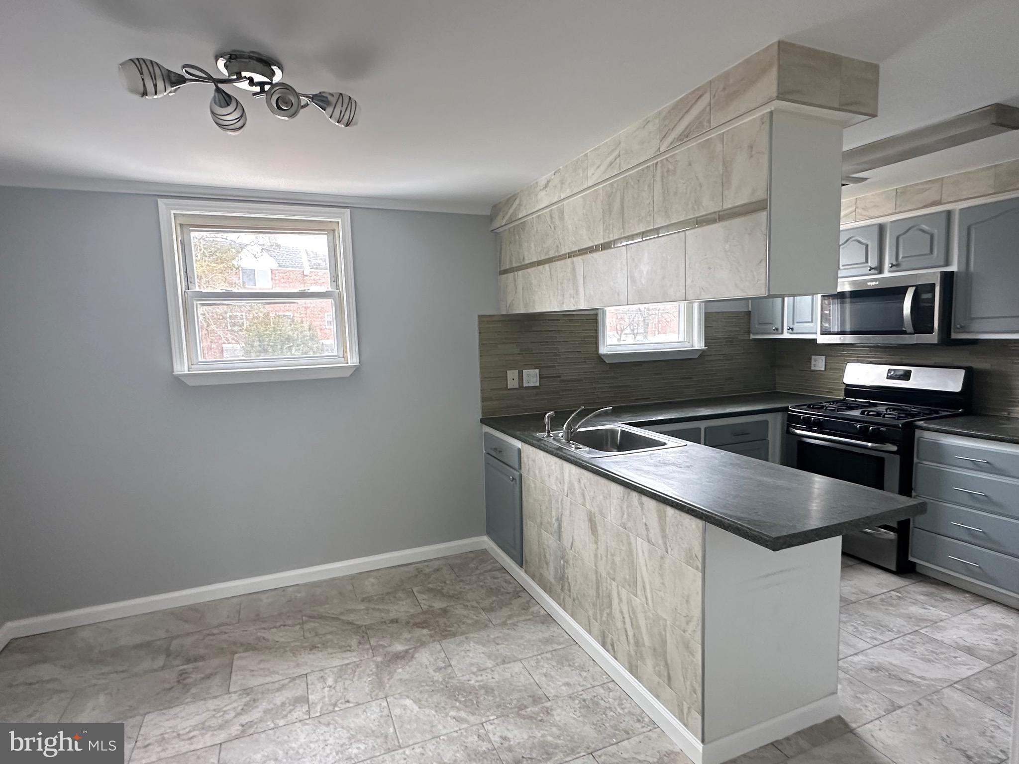 346 Ridgeway Place Philadelphia, PA 19116 - Photo 8 of 19 a kitchen with a stove and a microwave