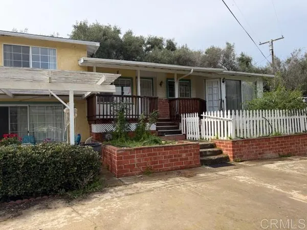 front view of a house with a fence