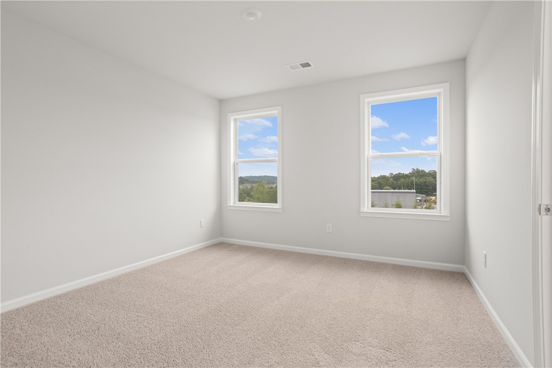 631 Sweetspire Trail, Unit 148 Seneca, SC 29678 - Photo 27 of 36 A quiet bedroom featuring plush carpet and dual windows offering serene outdoor views.