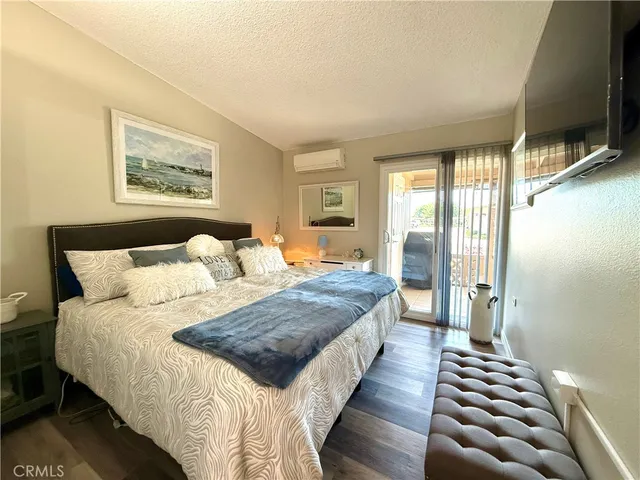 a bedroom with bed and wooden floor