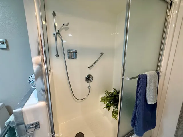 a bathroom with a glass shower door