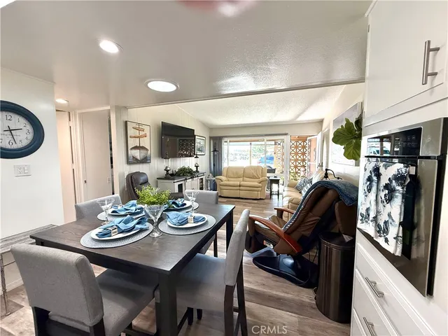 a view of a dining room with furniture and a chandelier