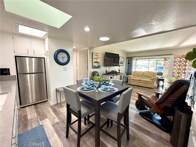 a view of a dining room with furniture and a large window