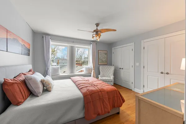 a bedroom with a bed and a window