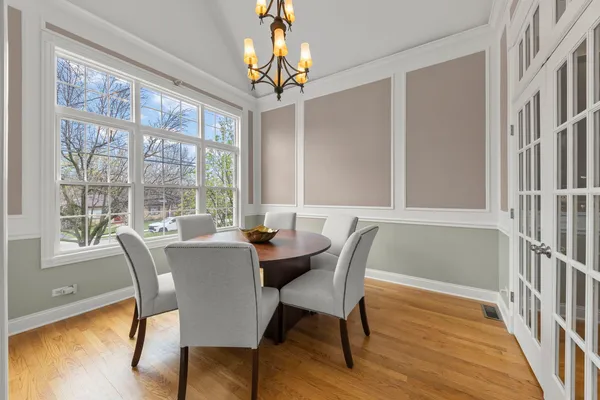 a view of a dining room with furniture wooden floor and chandelier