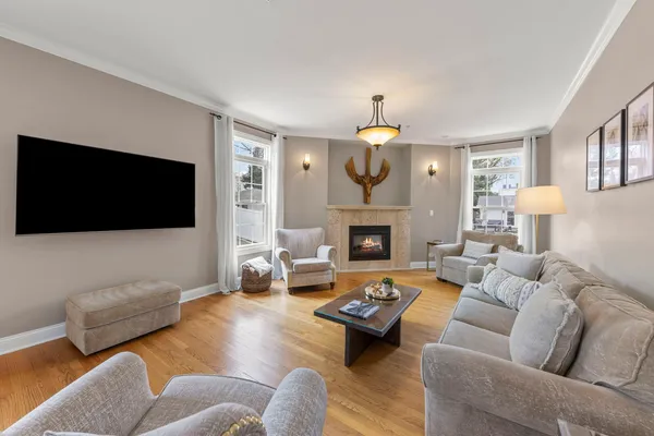 a living room with fireplace furniture and a wooden floor