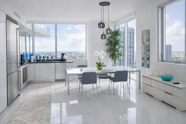 a kitchen with white cabinets sink and appliances