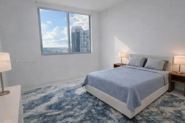 a room with painting on the wall and a window