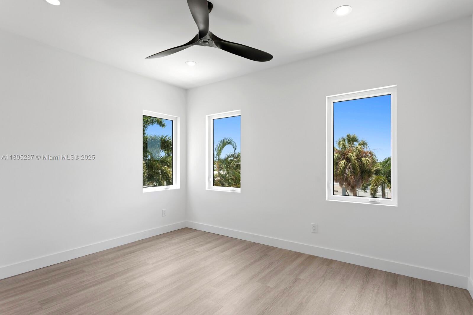 17059 Dolphin Drive St. Petersburg, FL 33708 - Photo 16 of 70 a view of an empty room with window and wooden floor