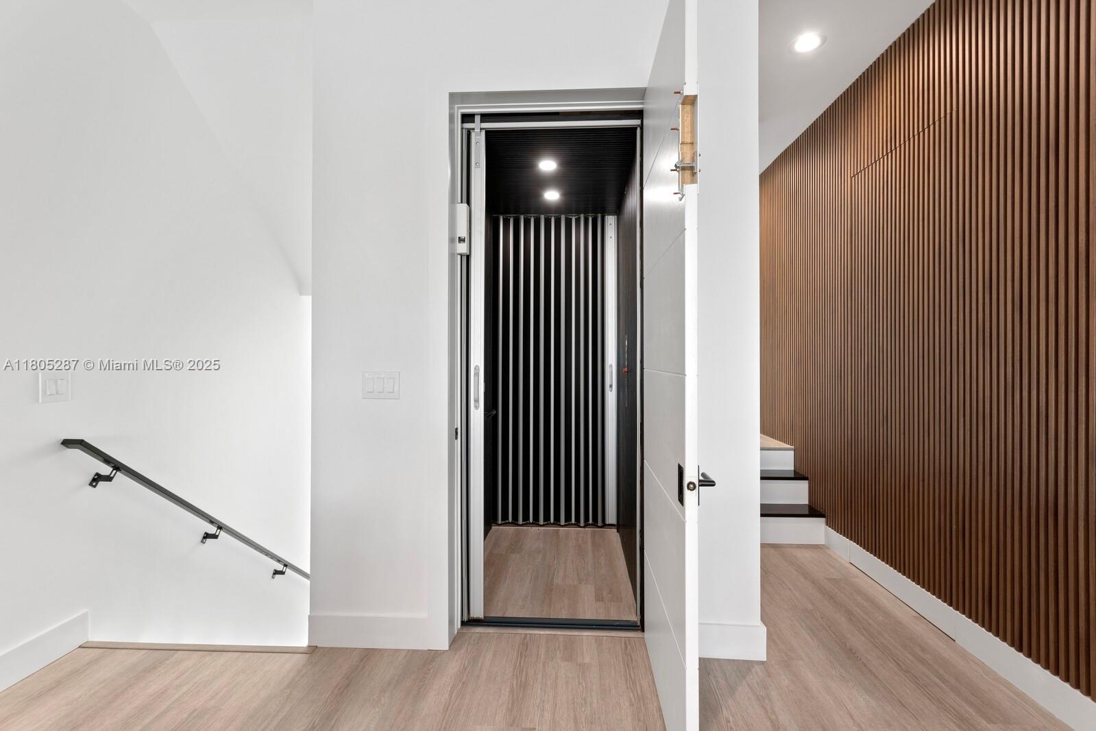 17059 Dolphin Drive St. Petersburg, FL 33708 - Photo 32 of 70 a view of hallway with stairs and wooden floor