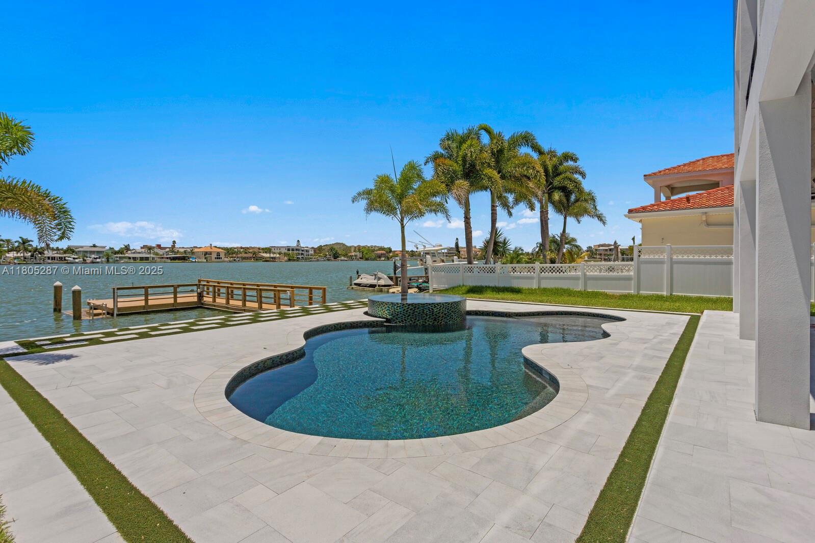 17059 Dolphin Drive St. Petersburg, FL 33708 - Photo 47 of 70 a view of a swimming pool with a lounge chair