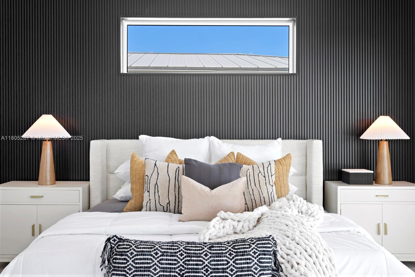 17059 Dolphin Drive St. Petersburg, FL 33708 - Photo 57 of 70 a bedroom with a bed and a lamp