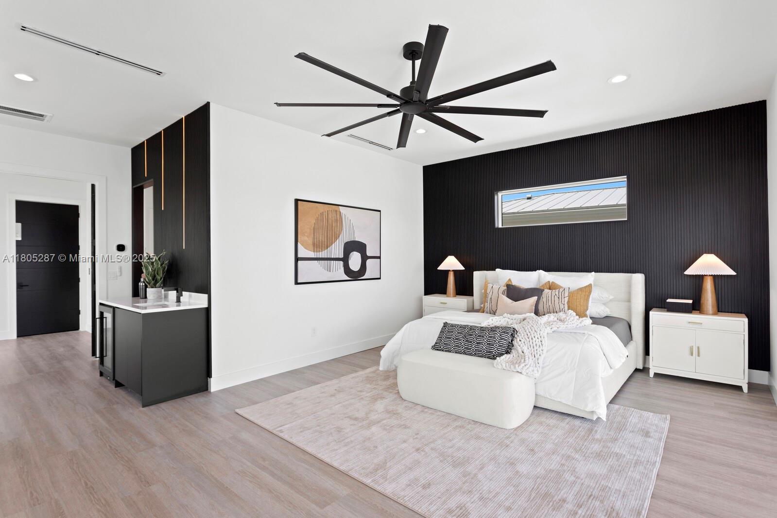 17059 Dolphin Drive St. Petersburg, FL 33708 - Photo 58 of 70 a bedroom with a large bed and a chandelier