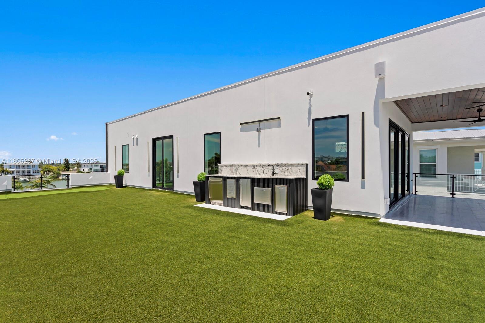 17059 Dolphin Drive St. Petersburg, FL 33708 - Photo 66 of 70 a view of a house with a backyard