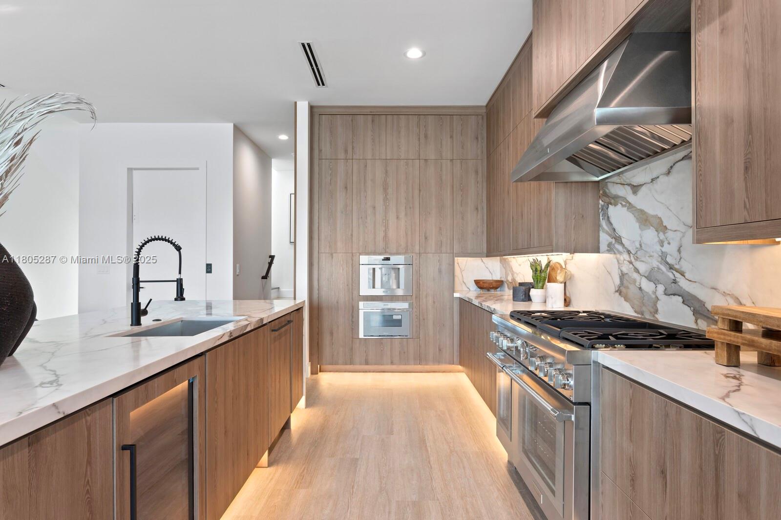 17059 Dolphin Drive St. Petersburg, FL 33708 - Photo 8 of 70 a kitchen with stainless steel appliances a sink stove and cabinets
