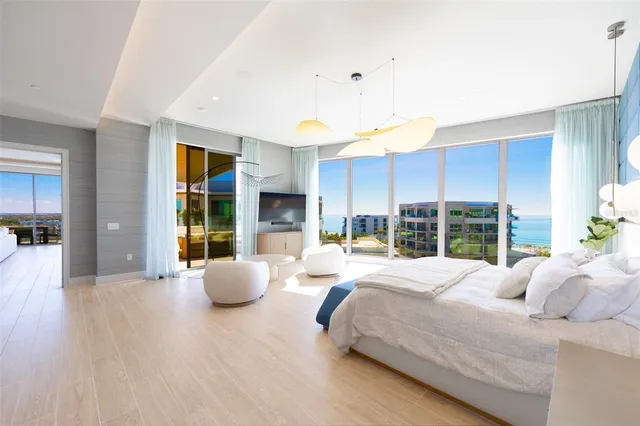 a bedroom with a bed a couch and a window