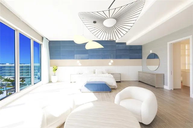 a bedroom with a bed a couch and a window