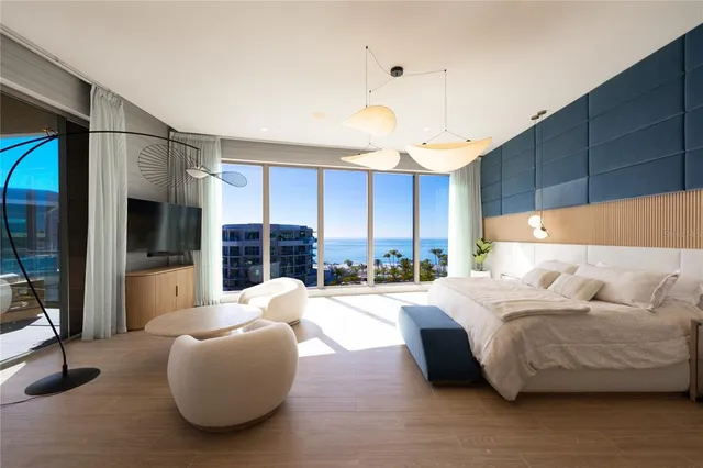 a bedroom with a bed and a lamp with the wooden floor