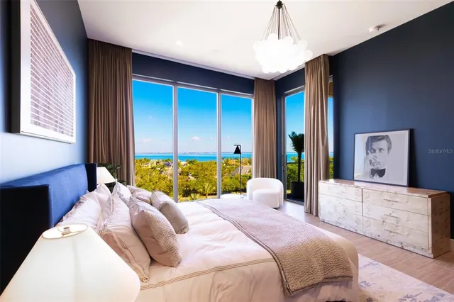 a bedroom with a bed and glass door