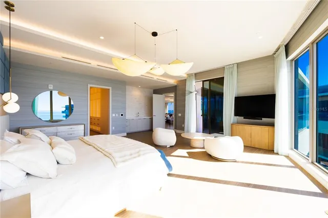 a room with furniture and a floor to ceiling window