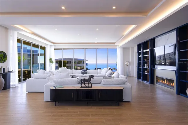 a living room with fireplace furniture and wooden floor