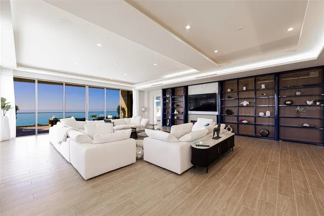 a view of a dining room with furniture wooden floor and chandelier