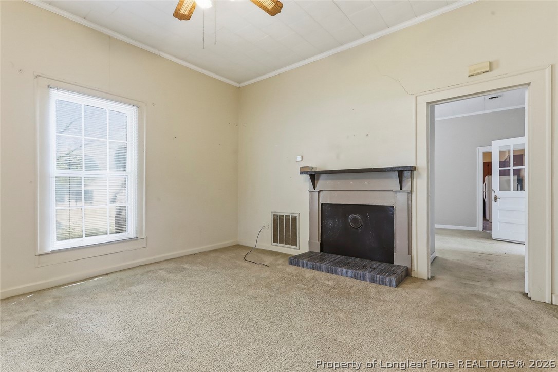 249 Nicholson Road Rockingham, NC 28379 - Photo 16 of 47 an empty room with windows and fireplace