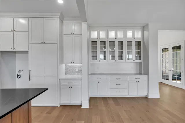 a kitchen with stainless steel appliances granite countertop a stove a sink and a wooden floors