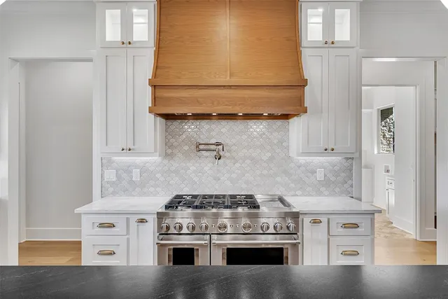 a kitchen with stainless steel appliances a stove sink and cabinets