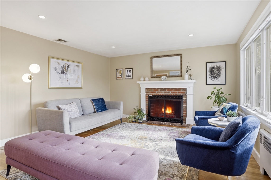 115 Collincote Street Stoneham, MA 02180 - Photo 4 of 25 a living room with furniture and a fireplace