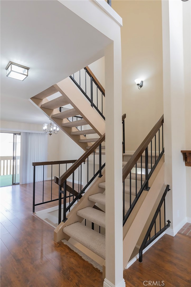 28205 Ridgepoint Court Rancho Palos Verdes, CA 90275 - Photo 15 of 33 a view of staircase with lots of frames on wall and wooden floor