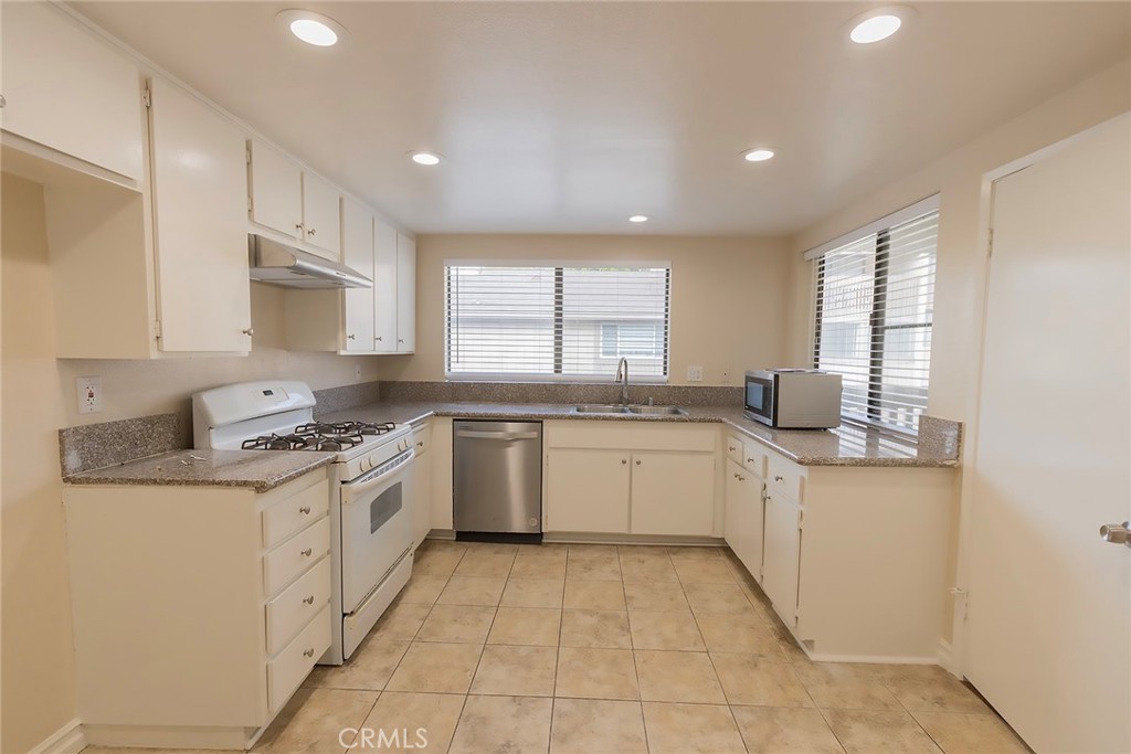 28205 Ridgepoint Court Rancho Palos Verdes, CA 90275 - Photo 6 of 33 a kitchen with granite countertop white cabinets and white appliances