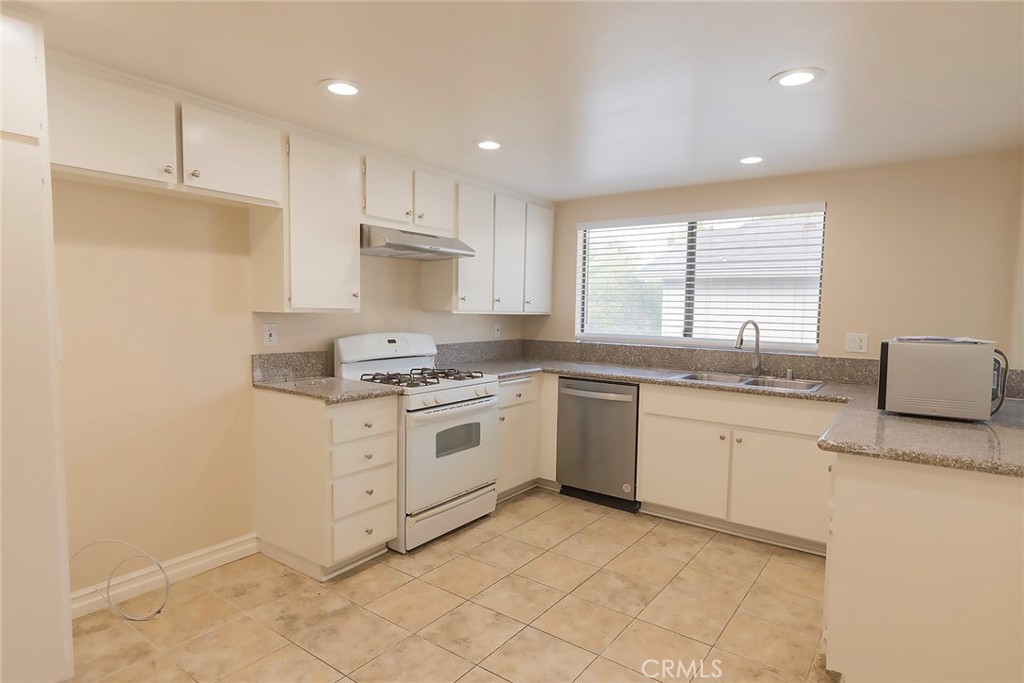 28205 Ridgepoint Court Rancho Palos Verdes, CA 90275 - Photo 7 of 33 a kitchen with granite countertop white cabinets white stainless steel appliances with a sink and dishwasher
