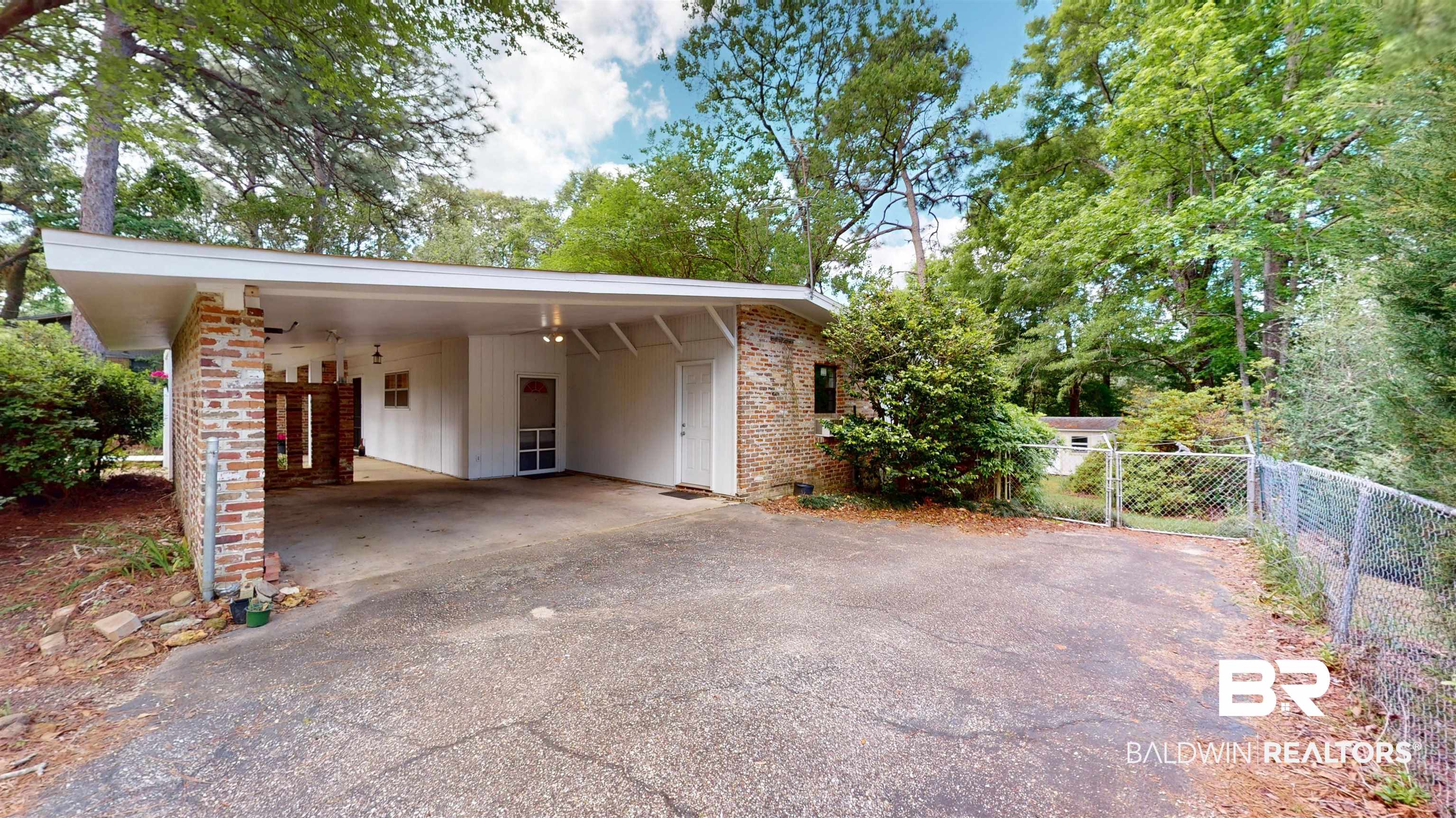 1075 Zurich Street Mobile, AL 36608 - Photo 5 of 35 View of front of property featuring driveway, brick siding, a carport, and a gate