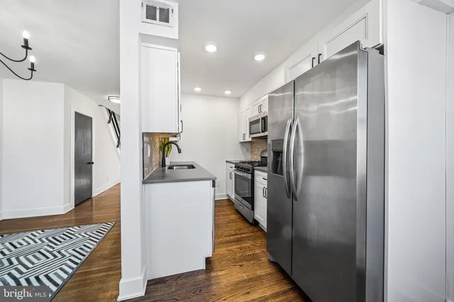 a kitchen with stainless steel appliances a refrigerator and a stove