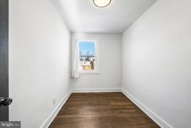 a view of a room with wooden floor and window
