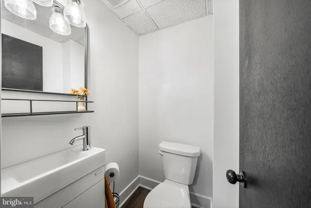 a bathroom with a sink a mirror and a toilet