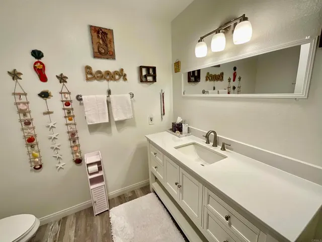 a bathroom with a sink vanity and mirror