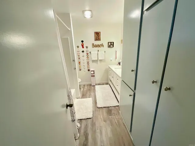 a view of a hallway with wooden floor