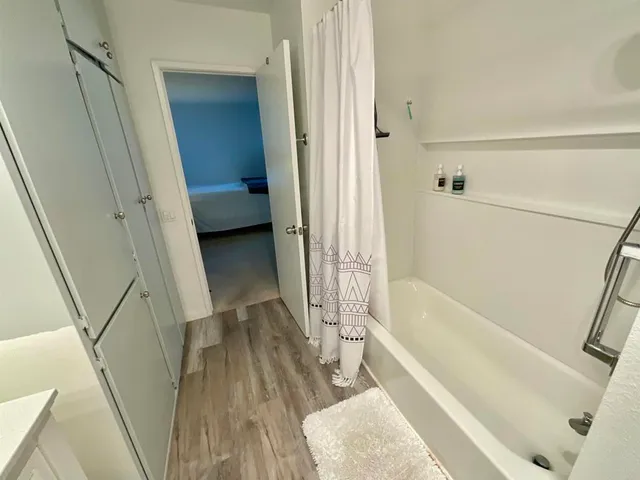 a bathroom with a tub and a shower