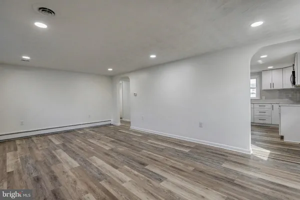 a view of a kitchen cabinets a sink and wooden floor