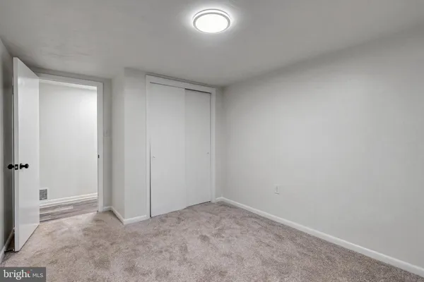 a view of an empty room with a fireplace