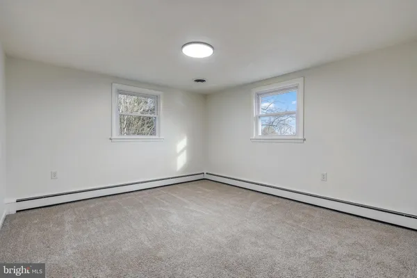 an empty room with a empty space and windows