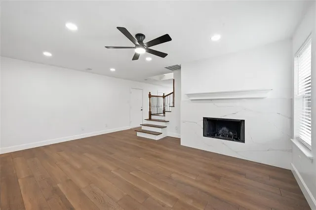 a view of an empty room with a fireplace and a window
