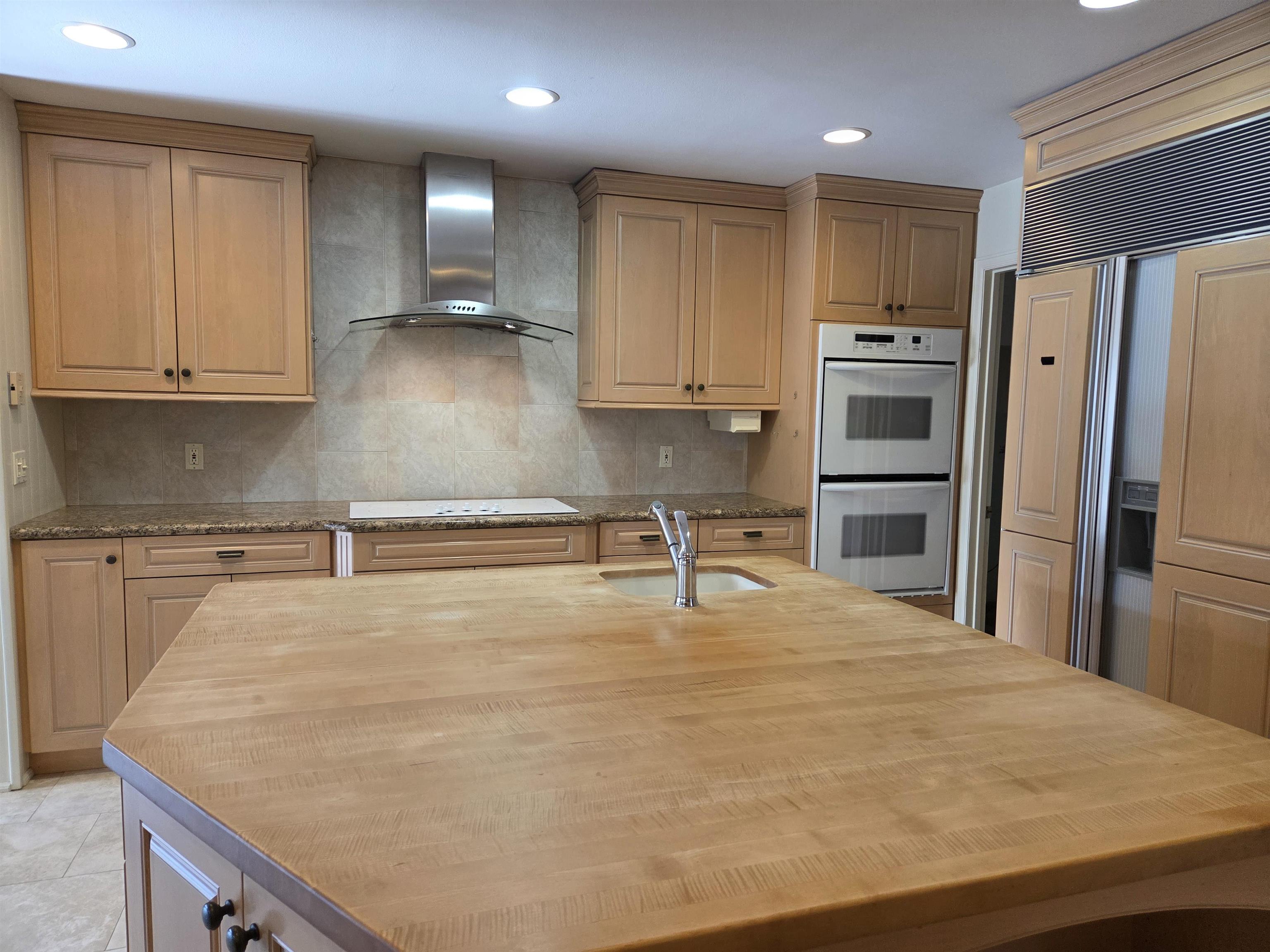 846 River Ranch Court Fruita, CO 81521 - Photo 12 of 24 a kitchen with granite countertop a refrigerator and a sink