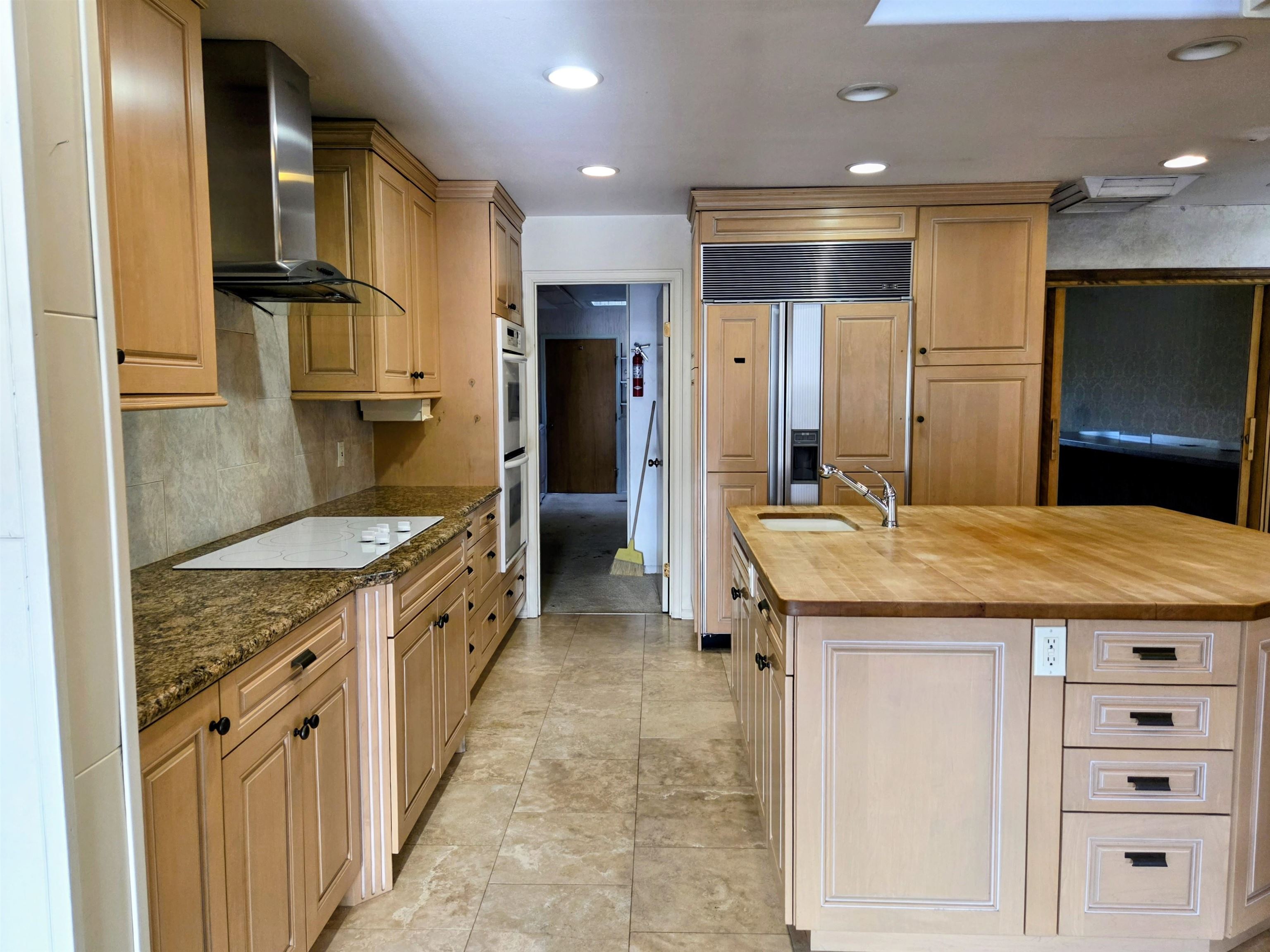 846 River Ranch Court Fruita, CO 81521 - Photo 13 of 24 a kitchen with kitchen island granite countertop a sink and refrigerator
